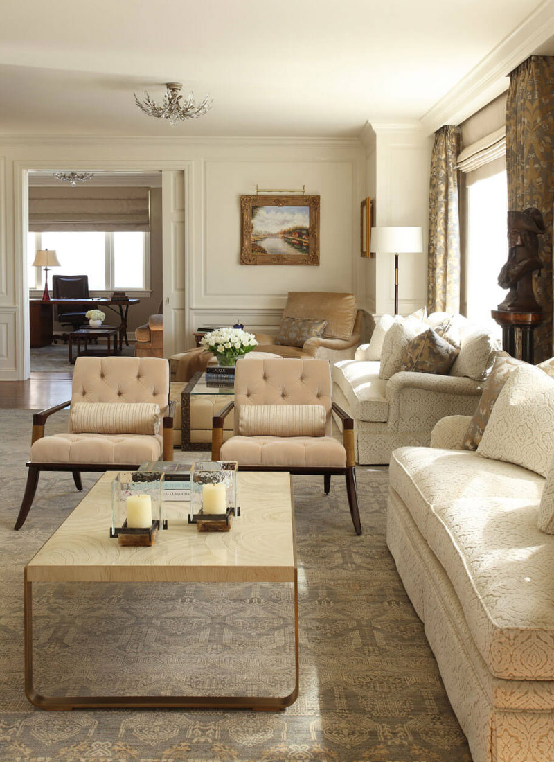 Living Room and home office with neutral color sofa, chairs with tan drapes.