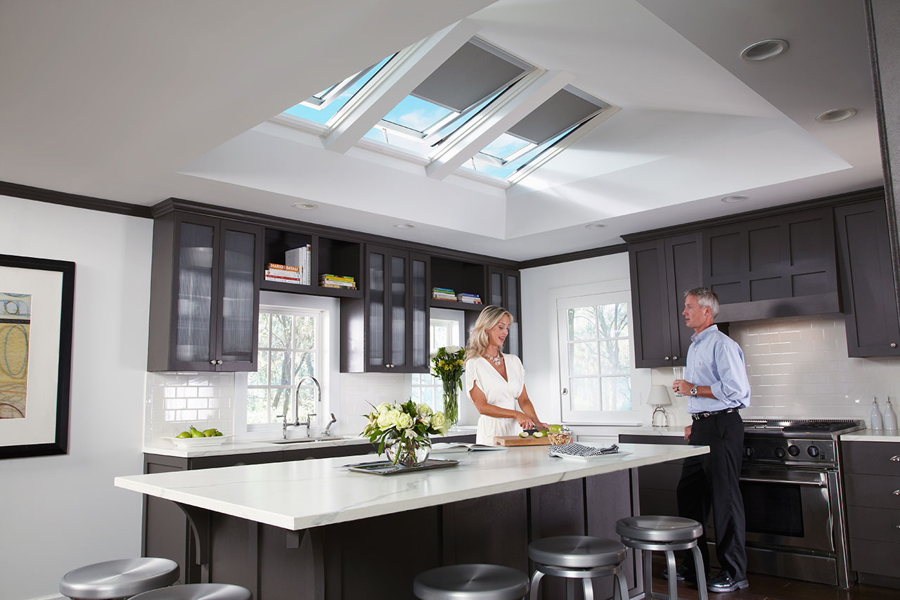 Woman and Man in their kitchen with natural light Sun Tunnels by Velux