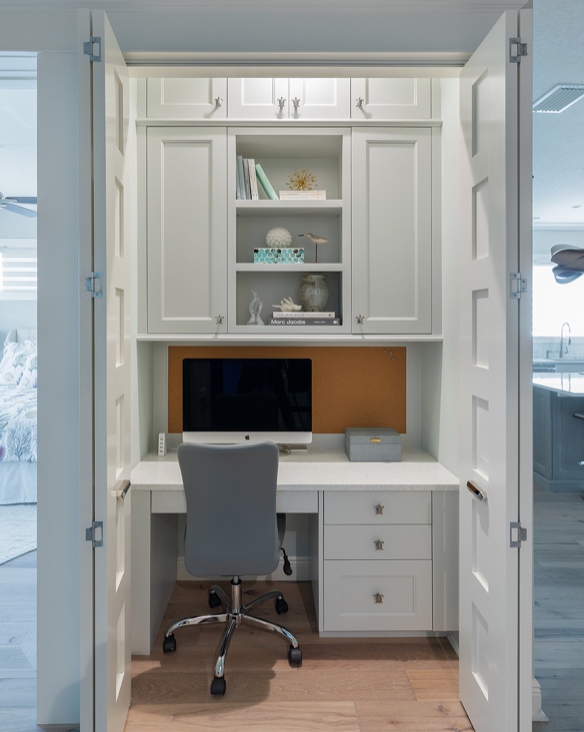 Home office with white built-in shelves and desk